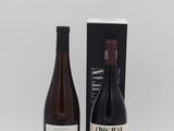 two bottles of wine are sitting next to each other on a table