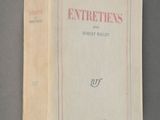 an old book on a gray surface with a red border