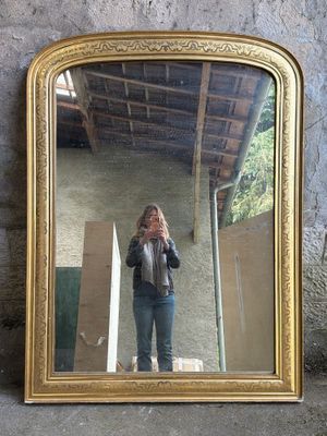 a woman taking a picture of herself in a mirror