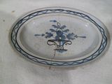 a blue and white plate with a bird on it