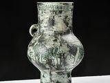 a vase with a design on it sitting on a table