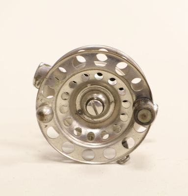 a close up of a fly reel on a white background