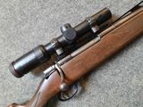 the rifle is laying on the floor next to the scope