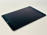 the tablet is sitting on a white table with a black screen