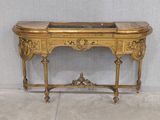 a gold table with a marble top on it