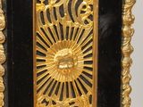 a black and gold clock sitting on a table