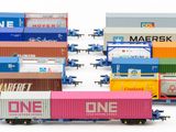 a lot of train cars that are lined up on the tracks