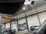 many cars parked inside of a building in a parking lot