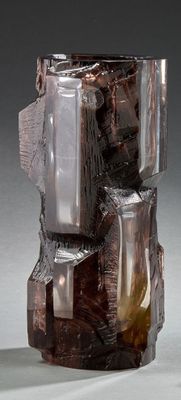 a glass vase that has a rock like structure on it