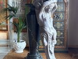 a statue of a woman holding a vase in the middle of a room