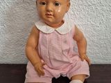 a small doll that is sitting on a table