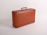 a brown suitcase sitting on a white surface