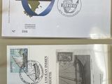two envelopes with stamps on them are sitting on a table