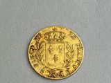 a close up of a gold coin with a coat of arms on it