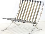 a metal chair that is sitting on a white floor