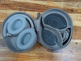 a pair of headphones in a case on a wooden floor