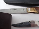two knives that are sitting next to each other on a table