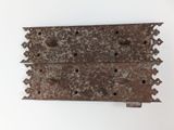 an old rusty piece of metal on a white surface