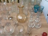 a table with a lot of glasses and a vase on it