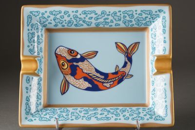 a blue and orange plate with a fish on it