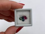 someone is holding a small white box with a ring inside of it