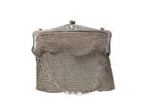 an antique silver mesh purse on a white background