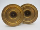 pair of antique brass candlesticks on a white background
