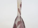 a small vase with a purple and white design on it