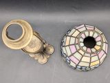 a small vase and a small candle holder sitting on a table