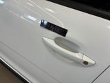 a close up of a car door handle with a sticker on it
