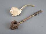 a pipe and a pipe holder sitting on a table