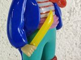 a figurine of a pirate with a sword and a hat
