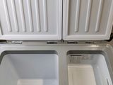 a white refrigerator with two open doors on the inside of it