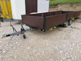a trailer with a trailer attached to it in the dirt