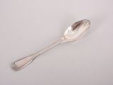 silver spoon on a white surface with a small spoon sticking out of it