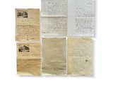 a collection of old letters and papers on a white surface