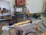 a table with an anvil on top of it in a garage