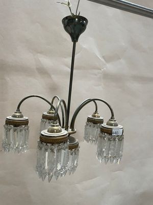 a chandelier that has five lights attached to it