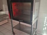 a small oven sitting on a cart in a kitchen