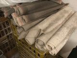 many rolls of fabric sitting on a crate in a room