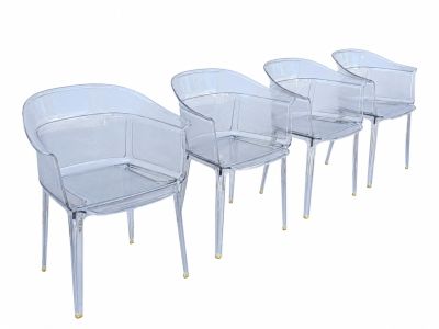 quatre chaises en plastique transparent disposées côte à côte sur une surface blanche
