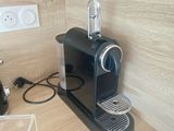 a black coffee machine sitting on a counter in a kitchen