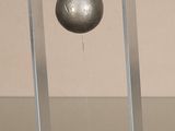 a metal ball sitting on a stand on a table