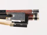 a close up of a violin bow and a bow rest