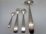 four forks and spoons sitting on a white table