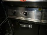 stainless steel counter top in a commercial kitchen with a toaster and toaster oven