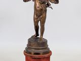 bronze figurine of an angel on a pedestal on a white background