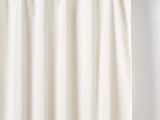 a close up of a curtain hanging on a rod in front of a white wall