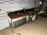 a kitchen with a sink and a table in it