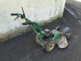 a small lawn mower that is sitting on the ground